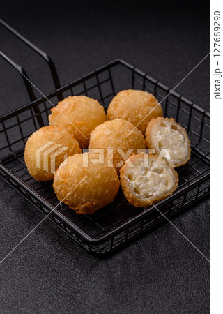Cheese fried balls or croquettes with potatoes or rice 127689290