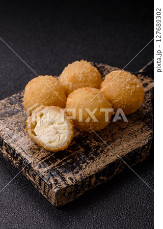 Cheese fried balls or croquettes with potatoes or rice 127689302