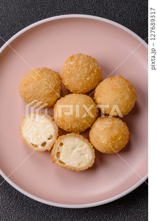 Cheese fried balls or croquettes with potatoes or rice Cheese fried balls or croquettes with potatoes or rice 127689317