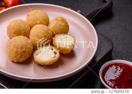 Cheese fried balls or croquettes with potatoes or rice 127689319