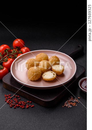 Cheese fried balls or croquettes with potatoes or rice 127689325