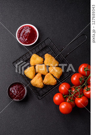Fried mozzarella or brie cheese with cranberry or raspberry sauce 127689343