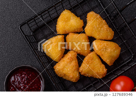 Fried mozzarella or brie cheese with cranberry or raspberry sauce Fried mozzarella or brie cheese with cranberry or raspberry sauce 127689346