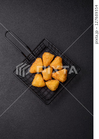 Fried mozzarella or brie cheese with cranberry or raspberry sauce Fried mozzarella or brie cheese with cranberry or raspberry sauce 127689354