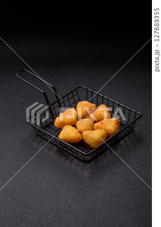 Fried mozzarella or brie cheese with cranberry or raspberry sauce 127689355
