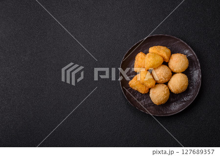 Fried mozzarella or brie cheese with cranberry or raspberry sauce 127689357