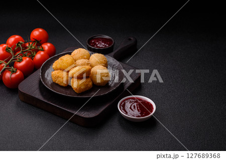 Fried mozzarella or brie cheese with cranberry or raspberry sauce Fried mozzarella or brie cheese with cranberry or raspberry sauce 127689368