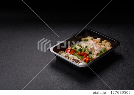 Bowl with caesar salad with chicken, parmesan cheese, tomatoes, croutons, lettuce leaves Bowl with caesar salad with chicken, parmesan cheese, tomatoes, croutons, lettuce leaves 127689503