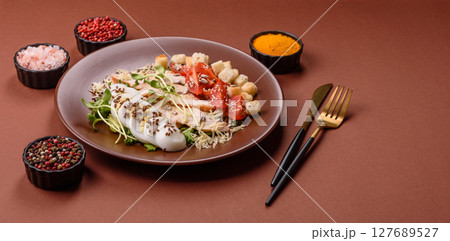 Bowl with caesar salad with chicken, parmesan cheese, tomatoes, croutons, lettuce leaves Bowl with caesar salad with chicken, parmesan cheese, tomatoes, croutons, lettuce leaves 127689527