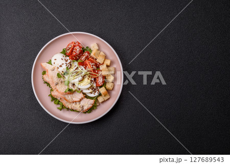 Bowl with caesar salad with chicken, parmesan cheese, tomatoes, croutons, lettuce leaves Bowl with caesar salad with chicken, parmesan cheese, tomatoes, croutons, lettuce leaves 127689543
