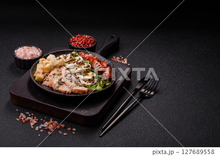 Bowl with caesar salad with chicken, parmesan cheese, tomatoes, croutons, lettuce leaves Bowl with caesar salad with chicken, parmesan cheese, tomatoes, croutons, lettuce leaves 127689558