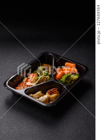Food bowl with tofu, quinoa, broccoli and carrots, microgreens 127689564
