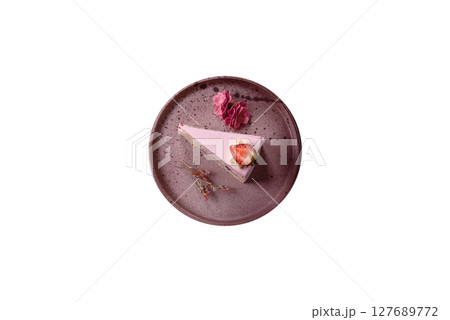 A slice of pink colored puff cake for a birthday celebration 127689772