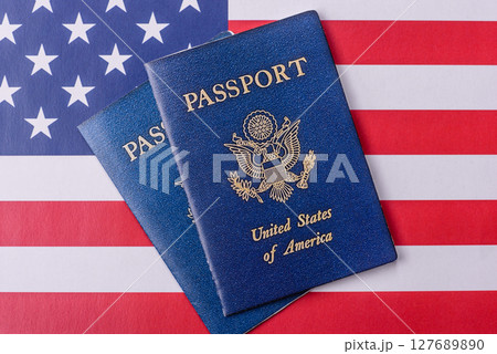 American passport against the background of the US national flag American passport against the background of the US national flag 127689890