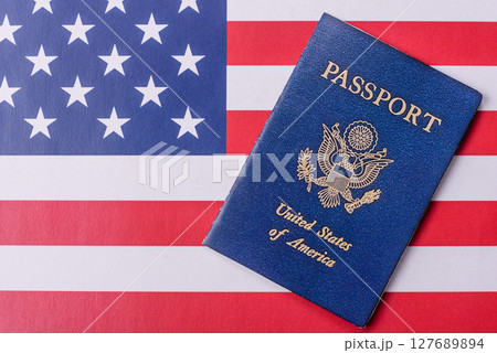 American passport against the background of the US national flag American passport against the background of the US national flag 127689894