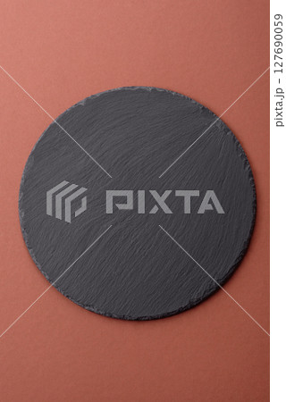 Empty ceramic plate on a monochrome brown background Empty ceramic plate on a monochrome brown background 127690059