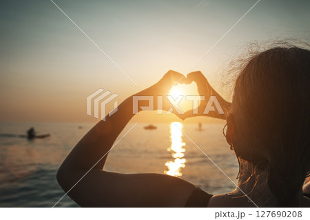 Heart Hands at Sunset Over the Sea 127690208