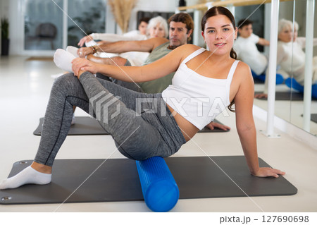 Portrait of people practicing Matsyendrasana known as Lord of Fishes Pose during group yoga training 127690698