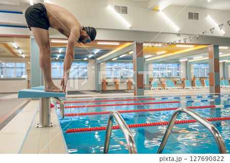 Man having a workout in the swimming pool 127690822