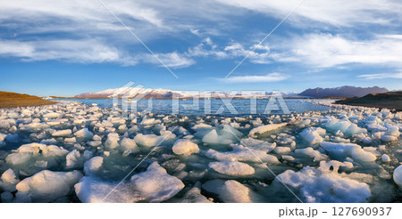 Ramarkable landscape with floating icebergs in Jokulsarlon glacier lagoon at sunset. 127690937