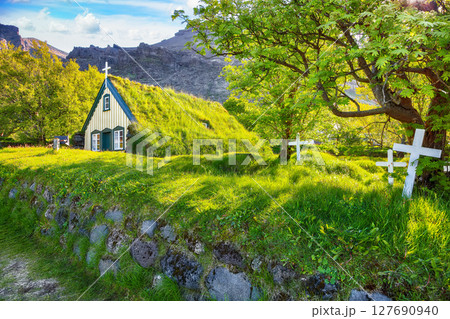 Impressive view of turf-top church Hofskirkja during sunset. Impressive view of turf-top church Hofskirkja during sunset. 127690940