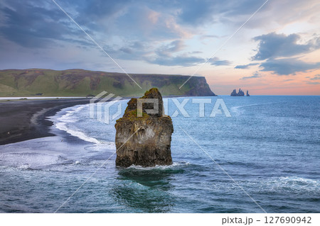 Impressive view of Kirkjufjara black sand beach from Dyrholaey promontory on Atlantic South Coast. 127690942