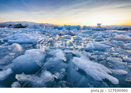 Ramarkable landscape with floating icebergs in Jokulsarlon glacier lagoon at sunset. Ramarkable landscape with floating icebergs in Jokulsarlon glacier lagoon at sunset. 127690960