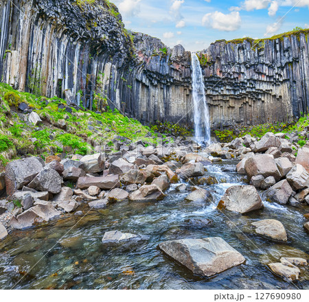 Impressive view of Svartifoss waterfall with basalt columns on southern part of Iceland. Impressive view of Svartifoss waterfall with basalt columns on southern part of Iceland. 127690980
