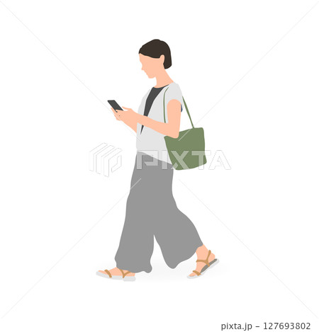 スマホを見ながら歩く若い女性 127693802