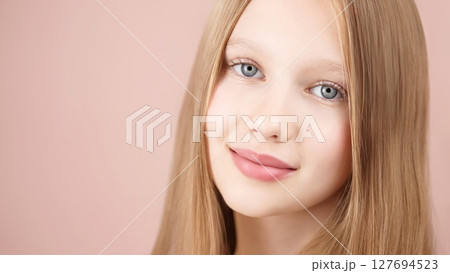 Face. Portrait of a funny smiling young girl. Blonde Caucasian girl with blue eyes isolated on pink background. Advertising concept skin care for teenagers. Hair care. Copy space. Self care Gen Alpha Face. Portrait of a funny smiling young girl. Blonde Caucasian girl with blue eyes isolated on pink background. Advertising concept skin care for teenagers. Hair care. Copy space. Self care Gen Alpha 127694523