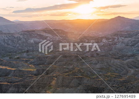 Golden sunset illuminating the desert landscape of gorafe, spain 127695489