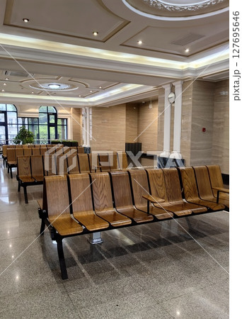 wooden seating arrangement in modern waiting area during daylight hours. closeup. 127695646