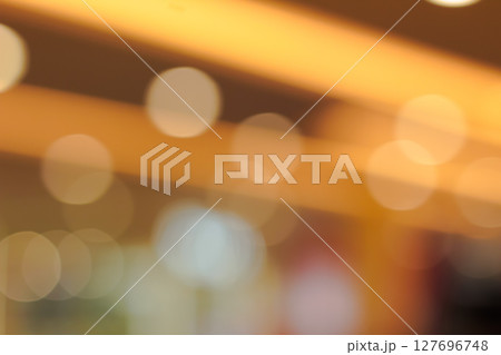 Soft warm golden light bokeh circles creating a beautiful abstract background texture effect Soft warm golden light bokeh circles creating a beautiful abstract background texture effect 127696748