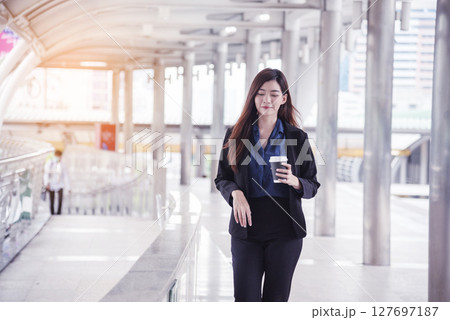 Portrait Businesswoman arms crossed smiling look at camera in modern city background. Happy Business people positive achievement standing and smile. Happy leader executive young asian women leader 127697187