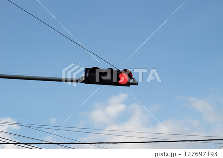 Red Traffic Light Against Blue Sky Red Traffic Light Against Blue Sky 127697193