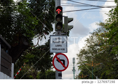 Red Traffic Light Against Blue Sky 127697198
