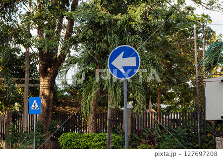 Blue Left Turn Traffic Sign in Urban Setting Blue Left Turn Traffic Sign in Urban Setting 127697208
