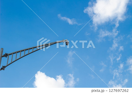 CCTV Security Camera on Pole Against Blue Sky CCTV Security Camera on Pole Against Blue Sky 127697262