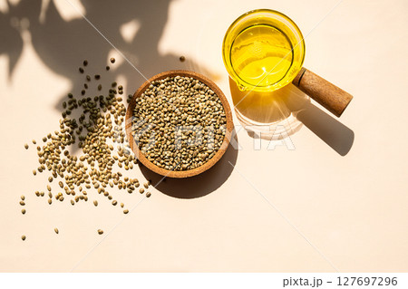 Hemp Seeds in Bowl and Hemp Seed Oil in a Clear Glass Pot. Cannabis Natural Product for Healthy Diet. Hemp Seeds in Bowl and Hemp Seed Oil in a Clear Glass Pot. Cannabis Natural Product for Healthy Diet. 127697296