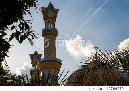 Islamic Architecture: Ornate Minaret with Gold Accents 127697594