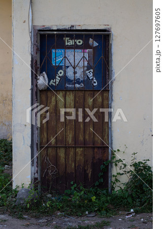 Gritty Urban Detail - Textured Rusty Gate and Peeling Paint 127697605
