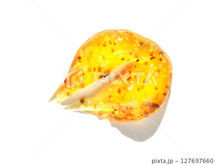 Close up of single yellow tomato seed with gelatinous coating on white Close up of single yellow tomato seed with gelatinous coating on white 127697660