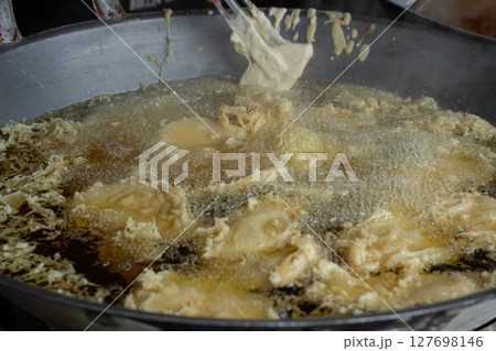 Process of frying bananas, cooked in hot oil Process of frying bananas, cooked in hot oil 127698146