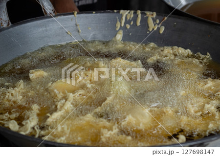 Process of frying bananas, cooked in hot oil Process of frying bananas, cooked in hot oil 127698147