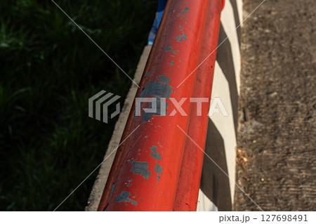 Red Metal Railing with Peeling Paint - Close-up Detail 127698491