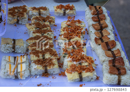 Assorted Fusion Sushi Rolls with Varied Toppings on Tray Assorted Fusion Sushi Rolls with Varied Toppings on Tray 127698843
