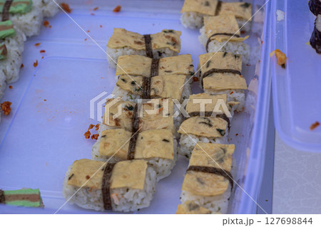 Assorted Fusion Sushi Rolls with Varied Toppings on Tray Assorted Fusion Sushi Rolls with Varied Toppings on Tray 127698844