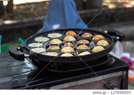 Street Food Vendor Preparing Small Round Pancakes 127698850