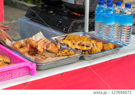 Assortment of Indonesian Fried Snacks at a Street Food Stall 127698872