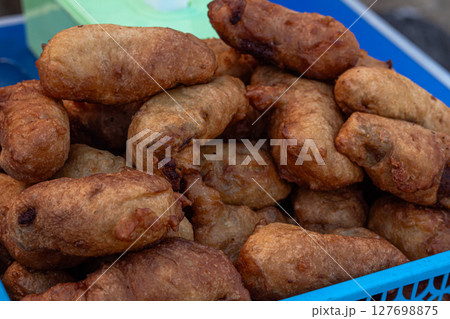 Assortment of Indonesian Fried Snacks at a Street Food Stall 127698875